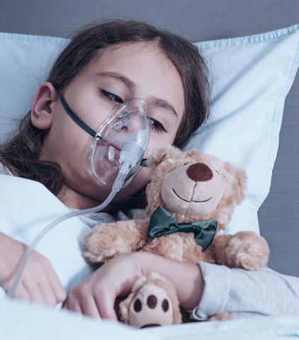 Child on oxygen in bed